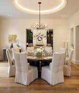 A formal dining room is located between the kitchen and living room. The space features a crystal-decorated antler chandelier underneath a circular raised ceiling.