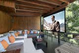 At one end of the deck is an open-air screening room with a retractable projector screen. A built-in couch completes this unique space.