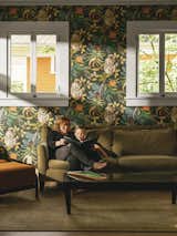 The formerly somber space got a splash of color and whimsy with monkey-themed Savuti  wallpaper by Cole &amp; Son. The sofa is from Lazar and the Gilda chair is by Porada.