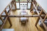 Looking down from the upstairs loft, the original post and beam structure defines the grand open space.