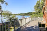 The side of the home offers a large deck with panoramic views of Putnam Lake.
