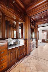 Former vanities and wash basins have been converted into wardrobes along a pass-through connecting the master bedroom with a sitting room.&nbsp;