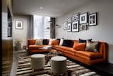 A velvet, orange sectional pairs with a plush, handwoven rug in the 900-square-foot Alexander Suite, which also features black oak and a grand terrace.