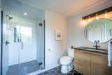 One of three full bathrooms, the master bathroom features modern amenities, including all-new cabinetry, tile work, and fixtures, as well as a large walk-in shower.