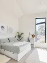 One end of the backyard home holds the bedroom with a wardrobe and an attached full bath.