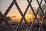 A chilly sunrise peeks through the lattice walls at the build site.