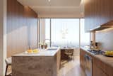 A look at the kitchen in one of the building's penthouse residences. Warm wood cabinetry and stone countertops complement the spaces's clean aesthetic.