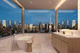The penthouse's master bathroom looks out over unobstructed views. "In all the residences, maximizing far-reaching views of Midtown, Downtown, and the Hudson River was a top priority," says Siza.