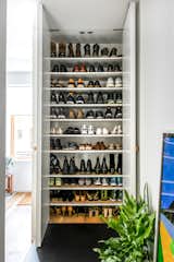 With floor-to-ceiling shelving, the shoe closet can easily convert into storage for any other additional items preferred to be left unseen.