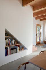A cut-out, triangular shelf underneath the staircase allows Cornuelle to display art and books.