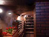 A brick cellar located on the lower level offers a temperature-controlled space for wine storage.