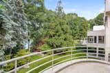 Outdoor and Back Yard Connected to the family room is a small balcony offering views of Mallard Lake. Several outdoors areas are spread throughout the home's multiple levels and wings.  Photo 9 of 13 in A MoMA Curator’s Estate Outside Manhattan Lists for $6.5M