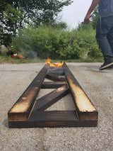 Joined pieces of timber are charred for a shou sugi ban treatment at the R-N-D Park.