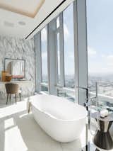 The home offers a total of six and a half bathrooms, this one with a free-standing soaking tub from which one can enjoy expansive views out over San Francisco. Marble-clad flooring and walls complete the industrial-chic vibe.