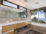 Bath Room, Alcove Tub, Tile Counter, Undermount Sink, and Limestone Floor In total, the home offers three bathrooms, all of which have been thoughtfully updated.  Photos from Own This Neutra-Designed Midcentury Stunner for $2M
