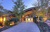 Currently owned by basketball legend and businessman Michael Jordan, 7495 Purple Sage in Park City, Utah, is built into a hillside overlooking the Glenwild Golf Course and the surrounding mountains. The driveway leads to the home’s grand main entrance.