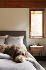 The couple’s Labradoodle, Marley, lounges on a Coyuchi duvet in the master bedroom.