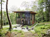 Olson Kundig designed this tall, treehouse-like cabin on a 40-acre property in the woods of Vermont. With a streamlined silhouette and simple materials—weathered Cor-Ten steel, timber and concrete—the getaway blends into its forest backdrop.