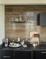Hickory planks form the kitchen backsplash and are used as flooring throughout.