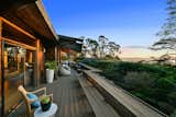 Yet, the home's location in the hills above Berkeley can be most appreciated from the upper-level outdoor space. A wrap-around deck provides panoramic views of the Bay and the Golden Gate Bridge in the distance.