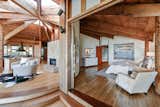 Raised flooring and edging designs help to delineate public and private spaces that otherwise open to each other throughout the home. Here, a master bedroom is carved out of one corner.