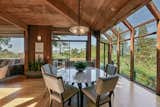 The formal dining area is located adjacent to the kitchen. Windows span across one wall, while sliding glass doors provide access to the deck.
