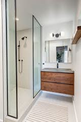 Bath Room, Concrete Counter, Ceiling Lighting, Porcelain Tile Floor, Open Shower, and Vessel Sink In addition to a custom walnut vanity, the second bathroom also features a stand-alone shower finished in Italian tile.  Photos from Actor Jason Thompson Lists His Idyllic Perch in the Hollywood Hills for $1.3M