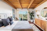 Bedroom, Bed, Chair, Dresser, Dark Hardwood, Rug, and Wall Wood beams continue into the master suite, which also features a walk-in closet and its own private deck.  Bedroom Dresser Rug Bed Chair Photos from Actor Jason Thompson Lists His Idyllic Perch in the Hollywood Hills for $1.3M