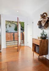 Hallway and Medium Hardwood Floor After purchasing the dwelling in 2006, Emmy-nominated actor Jason Thompson meticulously modernized the midcentury home, adding striking updates throughout. One example is the home's pivoting front door.   Photos from Actor Jason Thompson Lists His Idyllic Perch in the Hollywood Hills for $1.3M