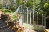 A custom-built greenhouse is situated on another side of the property.