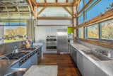 A closer look at the industrial-style kitchen. Outfitted with top-of-the-line appliances, the open space also features long marble countertops.