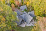 An aerial view of the compound, which is nestled between dozens of mature trees on the property. The 15-acre lot includes frontage along the Bantam River and abuts the Litchfield Land Trust acreage.