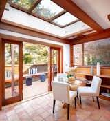 Skylights rest above a cozy eating area, complete with French doors that lead to a side terrace. Often recognized as the creator of "California design," Maybeck regularly integrated indoor/outdoor living into the homes he built, even as early as in the 1890s.