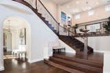 Dark hardwood lines the floors on both levels of the 6,200-square-foot dwelling. An open library and loft accentuate the home's large main foyer.