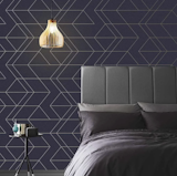 Graham &amp; Brown’s Balance wallpaper in navy and gold sports an attention-grabbing geometric pattern.