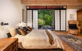 The master bedroom offers direct access to a small deck overlooking the lagoon-like swimming pool.