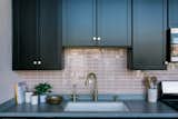 Macdonald selected glass tile from Fireclay, upgrading the sink and faucets as well. "The faucet sits so beautifully in front of the pink backsplash," she comments.&nbsp;