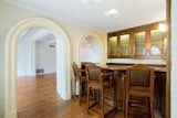 Arched doorways lead into the home's wet bar.