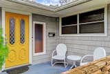 A bright yellow front door offers a warm welcome to residents and visitors alike.&nbsp;