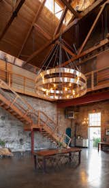 Boasting 45-foot-high vaulted ceilings, the loft-like entertaining area features many original details, such as exposed wooden beams and brickwork. Polished concrete floors run throughout.