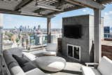 With expansive space and views in every direction, the penthouse's two-story outdoor area offers a private park in the sky. The lower level can be assessed from the living room or master bedroom and features several spots to sit and dine. Here, one of the lounge areas is located on the upper level and can be reached via an outdoor staircase.