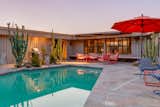 A glistening backyard pool provides the perfect complement to the home's characteristic turquoise color scheme. The surrounding patio offers yet another place for enjoying cooler desert nights.