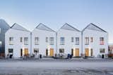 The compact row houses feature carefully angled solar panels that harness every moment of the sun.
