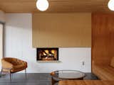 A restored concrete block fireplace offers warmth and coziness in the living room.