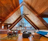 Bright and airy, the main living areas rest under the dynamic A-frame roof, which is gracefully split open by expansive clerestory windows. Stacked red brick intersect with exposed beams.  Photo 3 of 13 in This Midcentury A-Frame in Denver Offers Serious Storybook Appeal for $865K