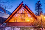Once the sun retreats, this 1954 A-frame warmly glows like a beacon of light.