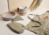 The spring/summer collection features a new color for MINNA’s grid oven mitt, potholder, and apron: sage.