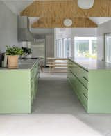 Michael and Hilary knew they would design their own rural residence ever since they cofounded architecture studio MOS in 2008. Michael explains that the couple felt a career obligation to experience their design skills firsthand, "to know what we’re offering to clients." In their kitchen, they used mint green cabinetry that connects the space to the outdoors.