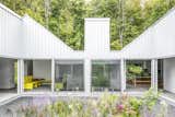 The home spreads out from a courtyard garden in a shape that resembles a hand traced on a sheet of paper. The structure of each “finger” nods to the traditional gable-sided barns that dot the area.