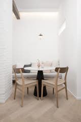 In the dining area, CH23 chairs by Carl Hansen &amp; Søn join a table with a Pedrali base.
